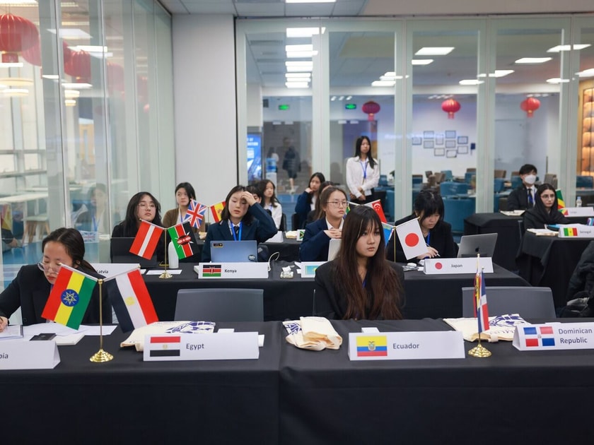 High school students at a Model UN conference table with country flags, demonstrating leadership extracurriculars valued in college admissions