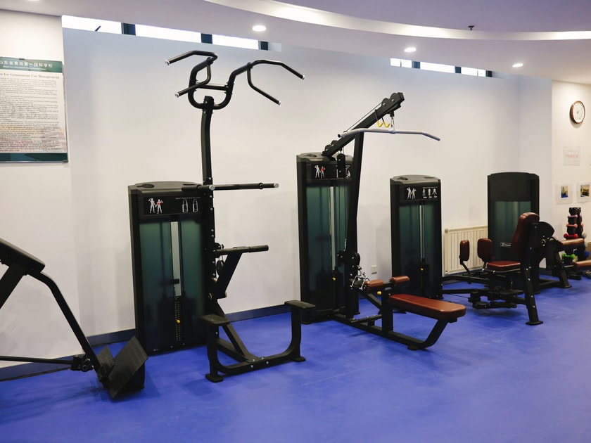 Academic Pressure on Students: Causes, Effects & Support 3 A modern school fitness and wellness center with exercise equipment, representing institutional investment in student physical and mental wellbeing