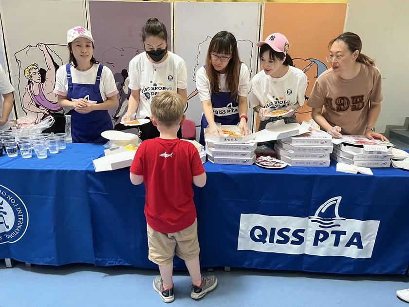 Leader in Me Program: How Schools Build Student Leaders 3 Students and adult volunteers serve food at a school PTA community event, showing parent and student collaboration