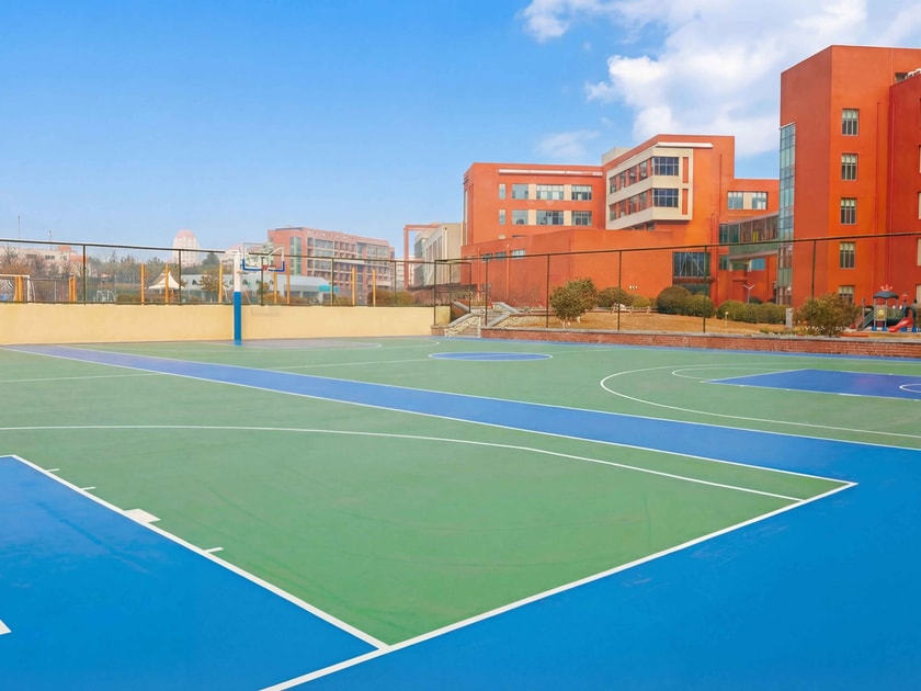 School Visit Tips: What to Look for on Campus 1 Modern multi-sport outdoor court on an international school campus in Qingdao on a clear day