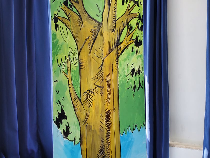 Service Learning in Schools: Building Real-World Impact 1 Student-painted tree mural on a classroom column, representing environmental awareness and creative service learning expression