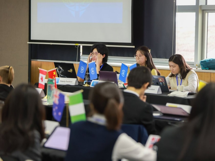 School Calendar Planning: Balancing Activities and Commitments 2 High school students at Model UN conference table managing a structured academic event schedule