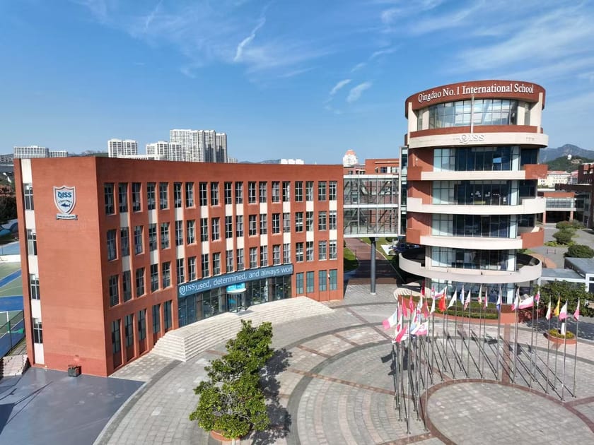 Teaching International School China: A Career Guide 1 Aerial view of Qingdao No. 1 International School campus buildings with urban Qingdao skyline