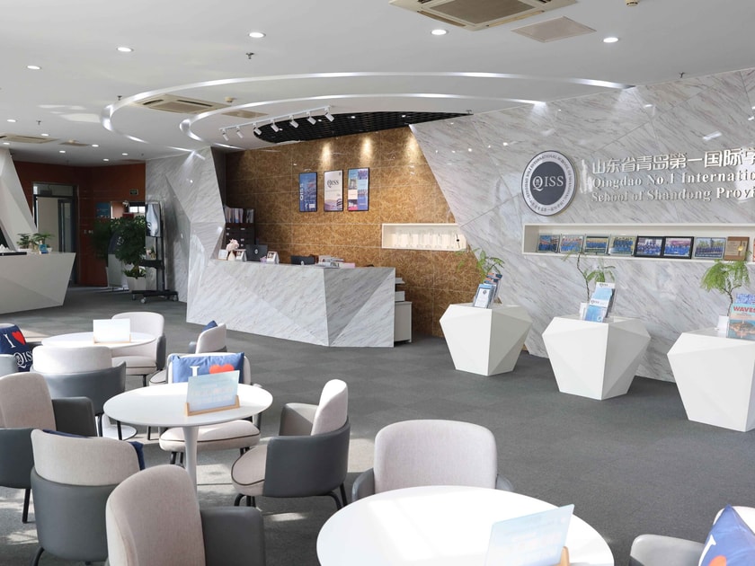 Teaching International School China: A Career Guide 2 Modern QISS school lobby with branded reception desk and marble interior for prospective teacher visits