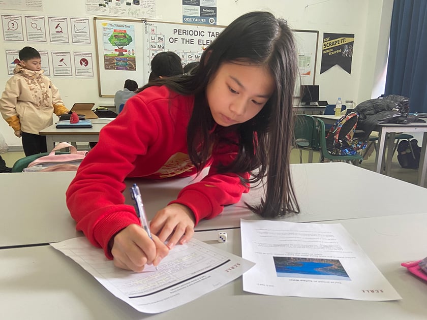 Understanding School Report Cards: A Parent's Guide 1 Lower school student concentrates on written work at a desk in a science classroom
