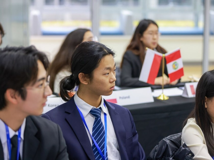 Choosing a University Major: A Parent's Guide 3 High school students in business attire with country flag nameplates engaged in an international Model UN conference