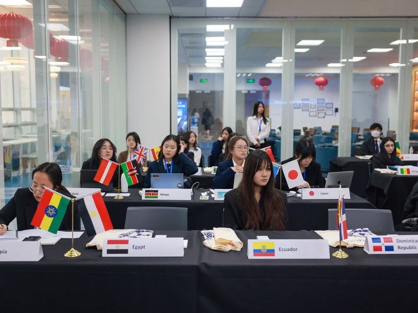 Raising a Bilingual Child: Benefits and Strategies 2 High school students at international Model UN conference with country flags representing multilingual global citizenship