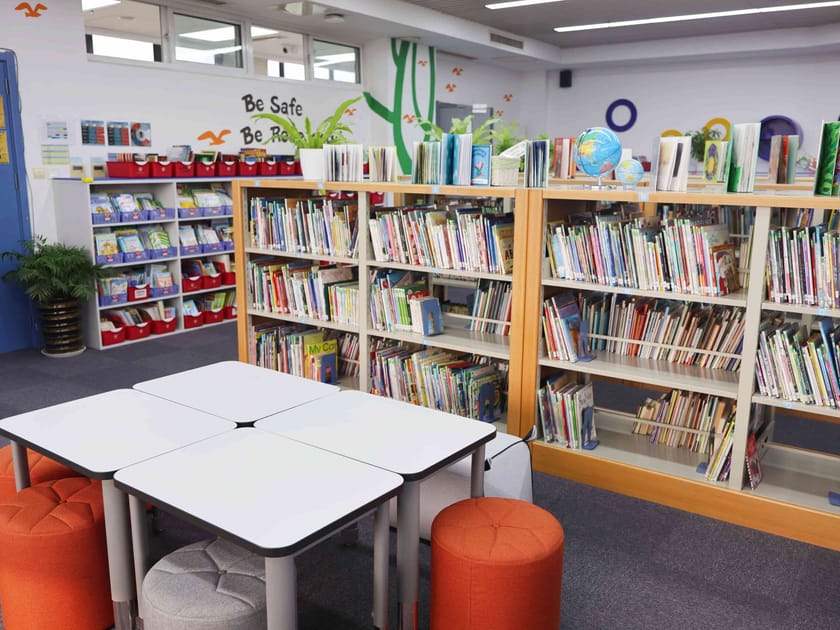 Summer Learning Loss: Keep Skills Sharp Over Break 2 Modern school library with extensive bookshelves and collaborative reading spaces