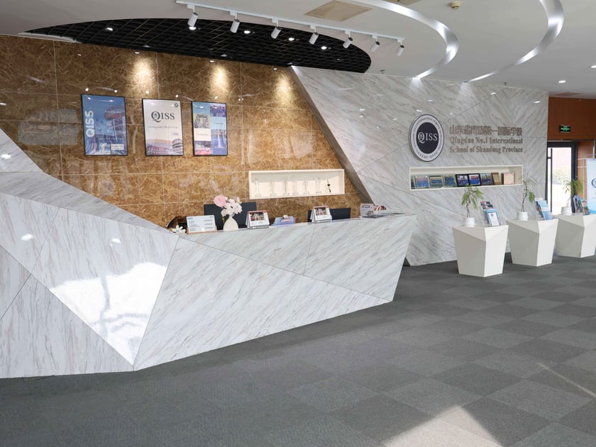 Test-Optional Admissions: A Guide for Students from China 1 QISS modern reception desk and school entrance — supporting students on every admissions path