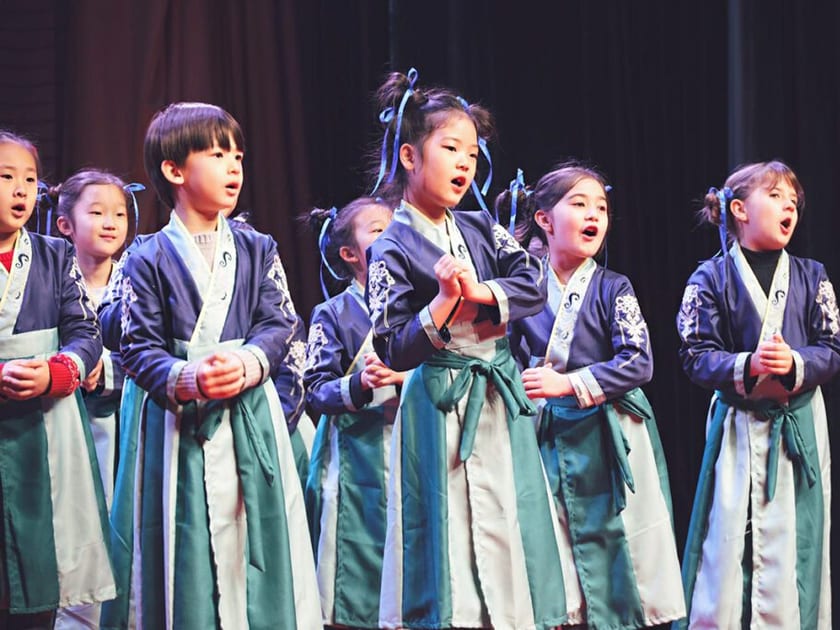 AP Chinese Language and Culture: A Guide for Students in China 2 QISS students in traditional Chinese costumes perform a song on stage