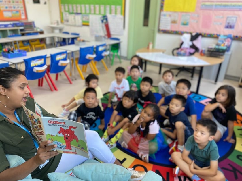 International Kindergartens in China: A Parent's Guide 2 A teacher reads a picture book aloud to young children sitting on a rug in a QISS classroom